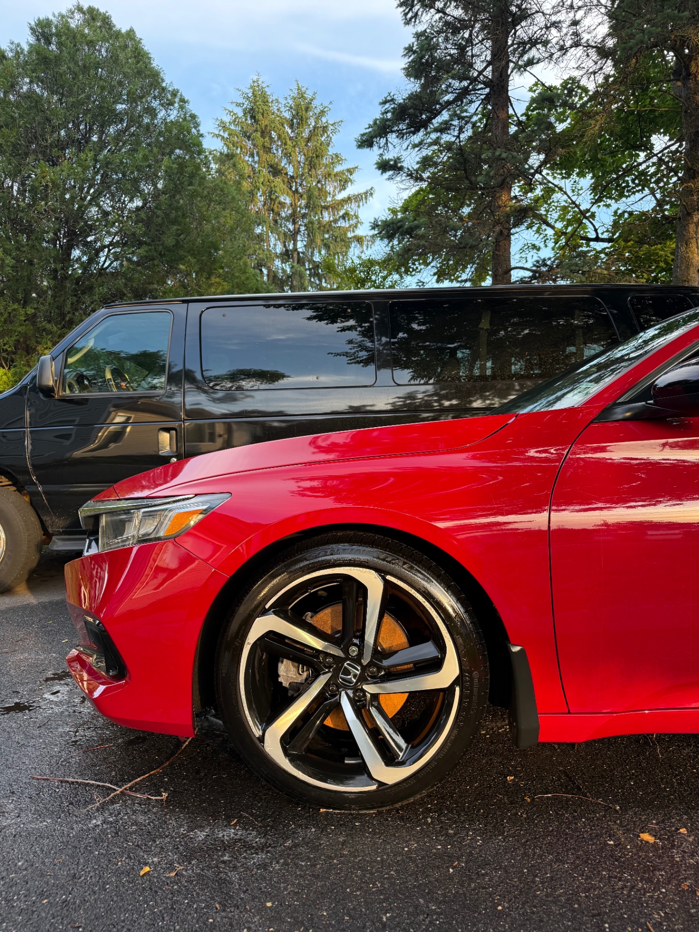 Red Honda Accord wheel cleaned and polished with fresh tire dressing after wheel detail
