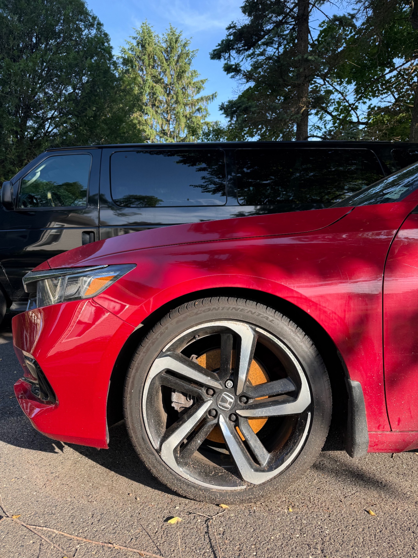 Red Honda Accord wheel covered in brake dust and road grime before wheel detail