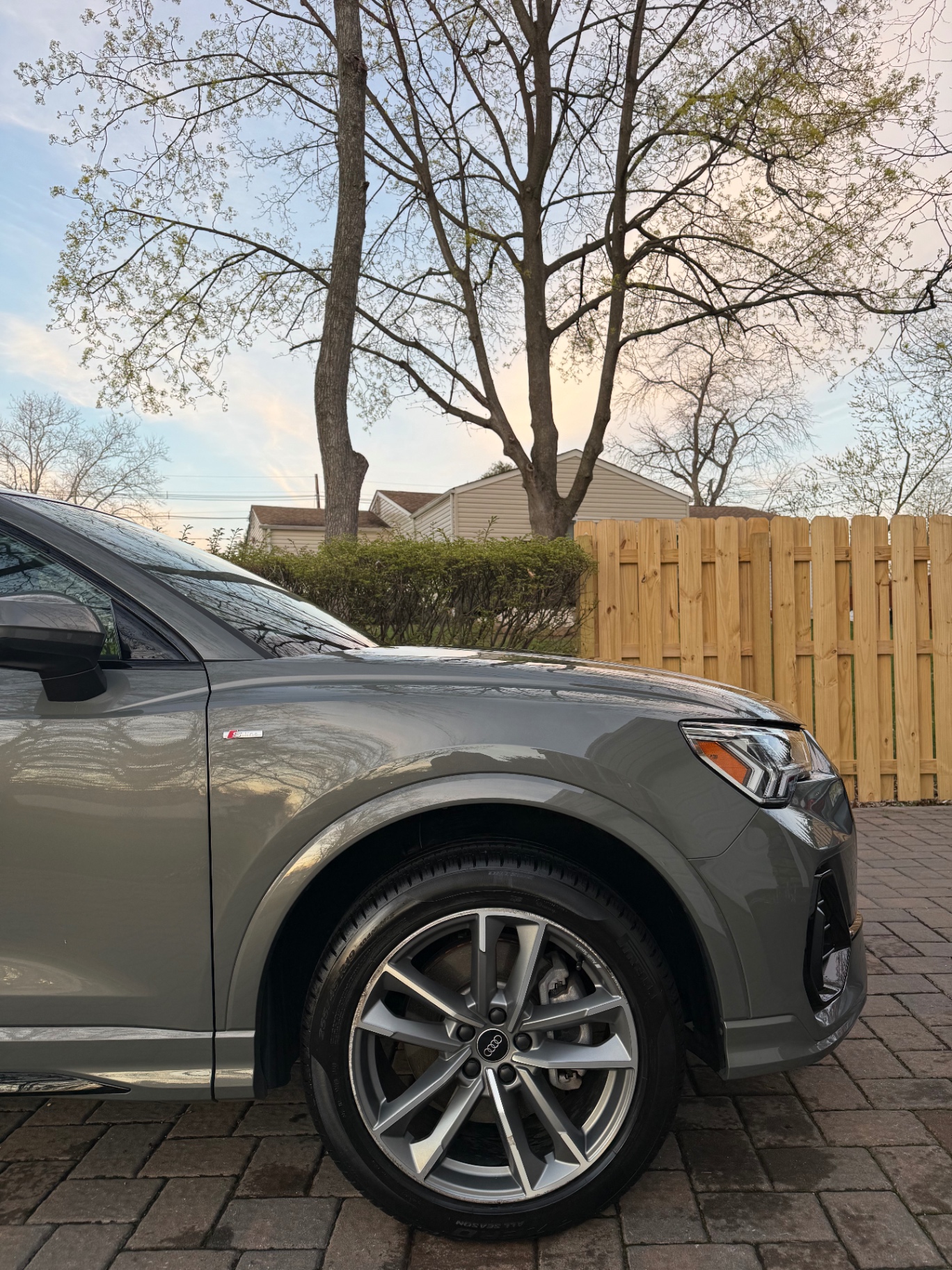 Audi Q3 with restored gloss and clean wheels after detailing