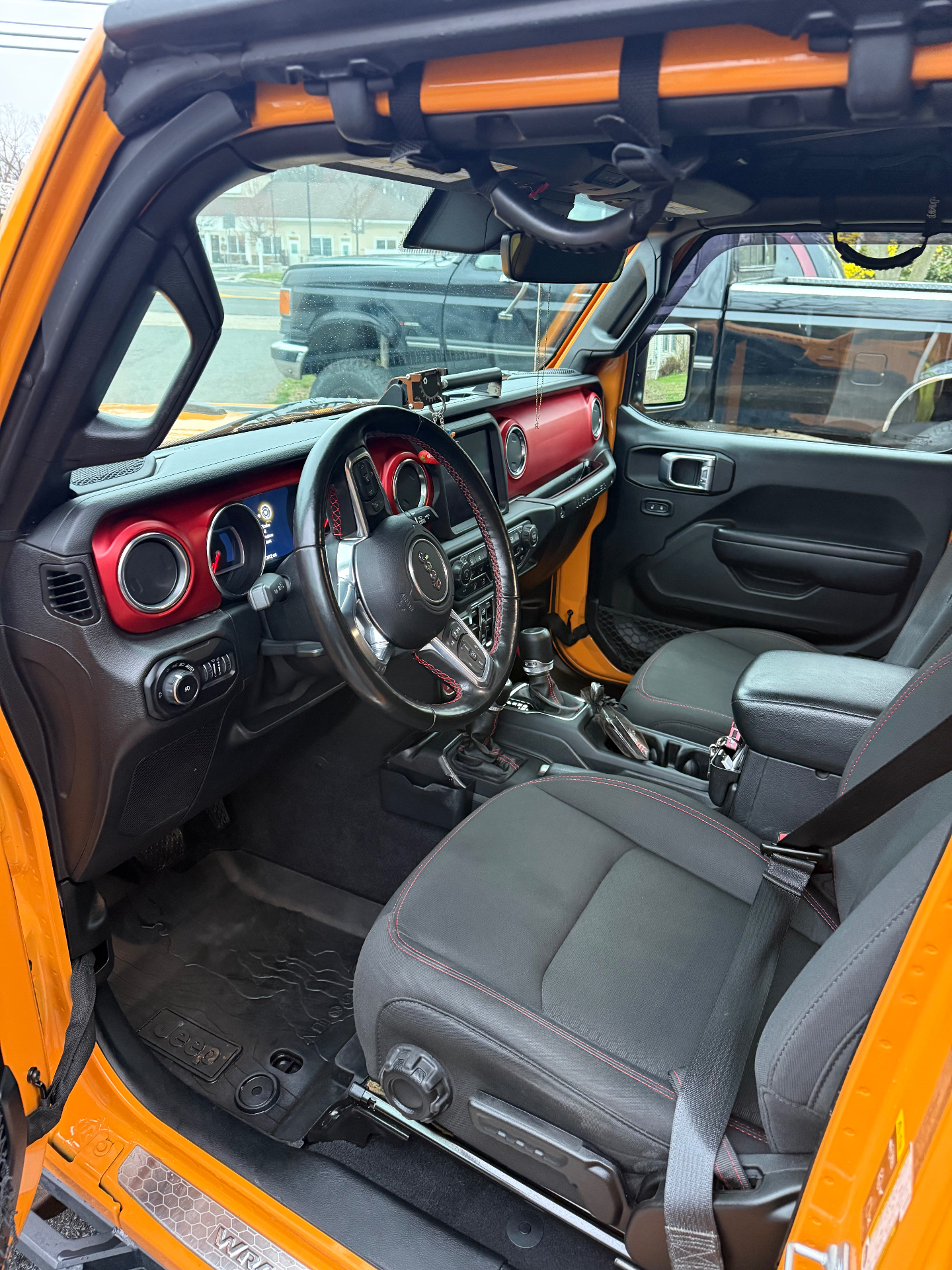 Jeep Wrangler interior spotless with clean dash and refreshed floor mats after detailing