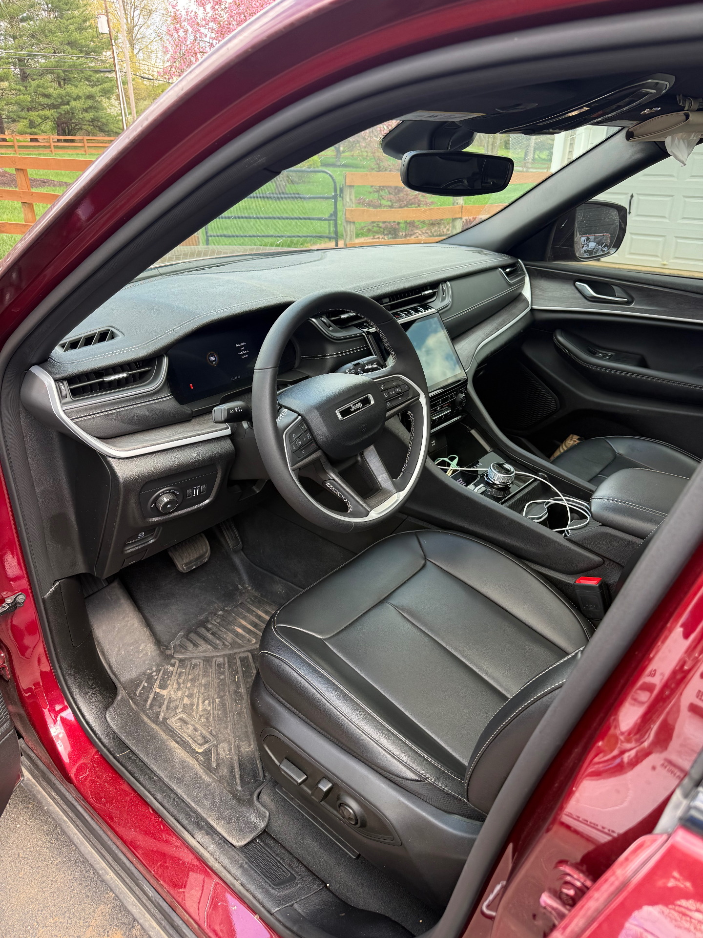 Jeep Grand Cherokee interior with dusty dash and dirty floor mats before detailing